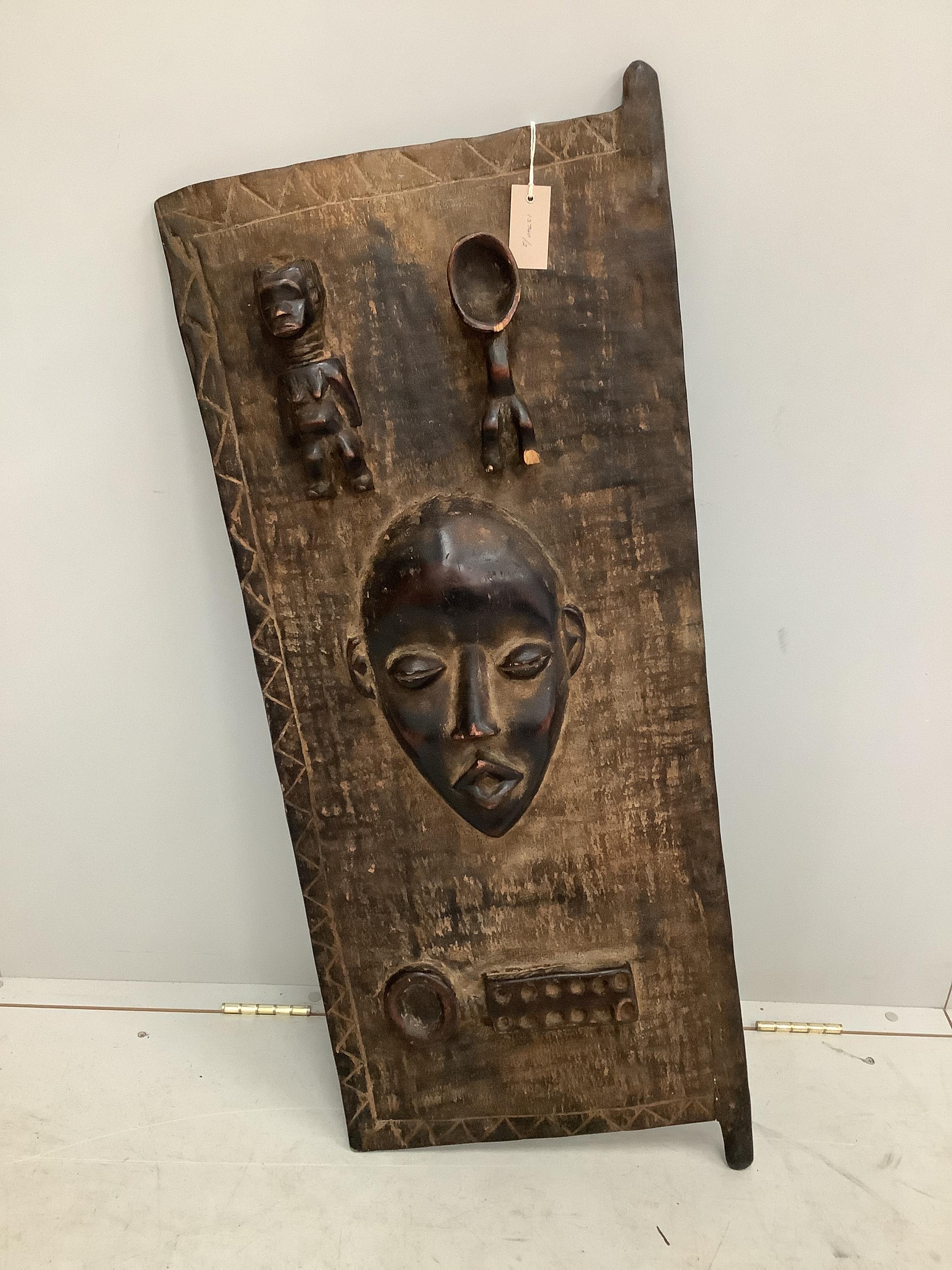 A Ghanaian carved wood panel / door, width 46cm, height 112cm